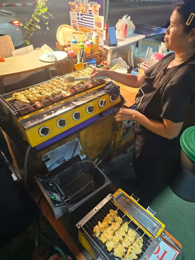 Fresh meat trays being prepared at the grill station