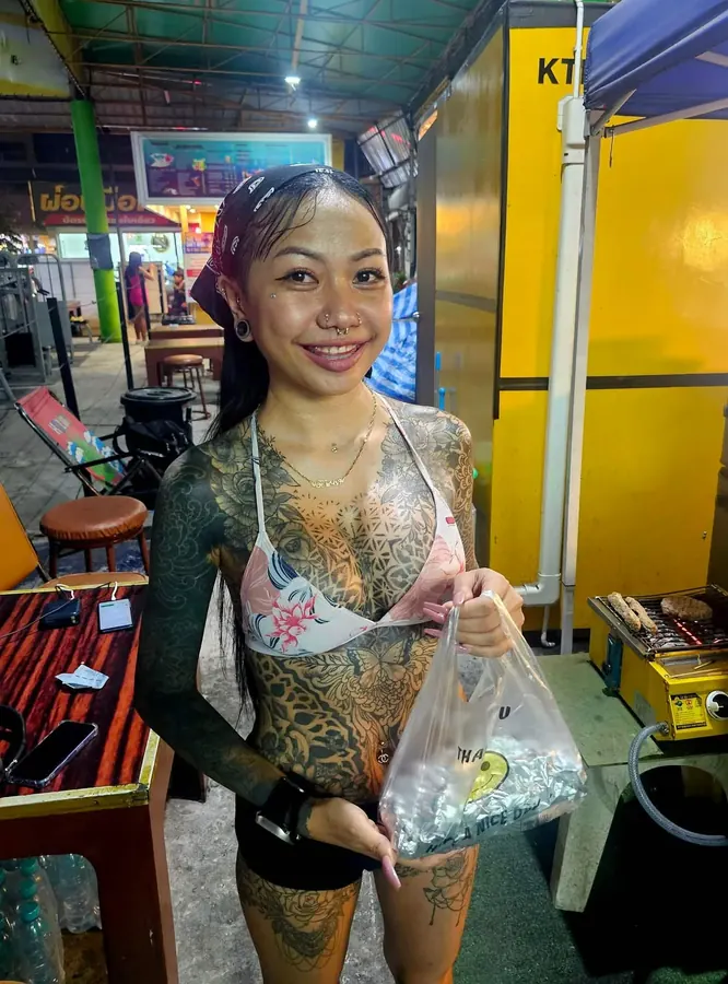 Customer with a pita souvlaki wrap