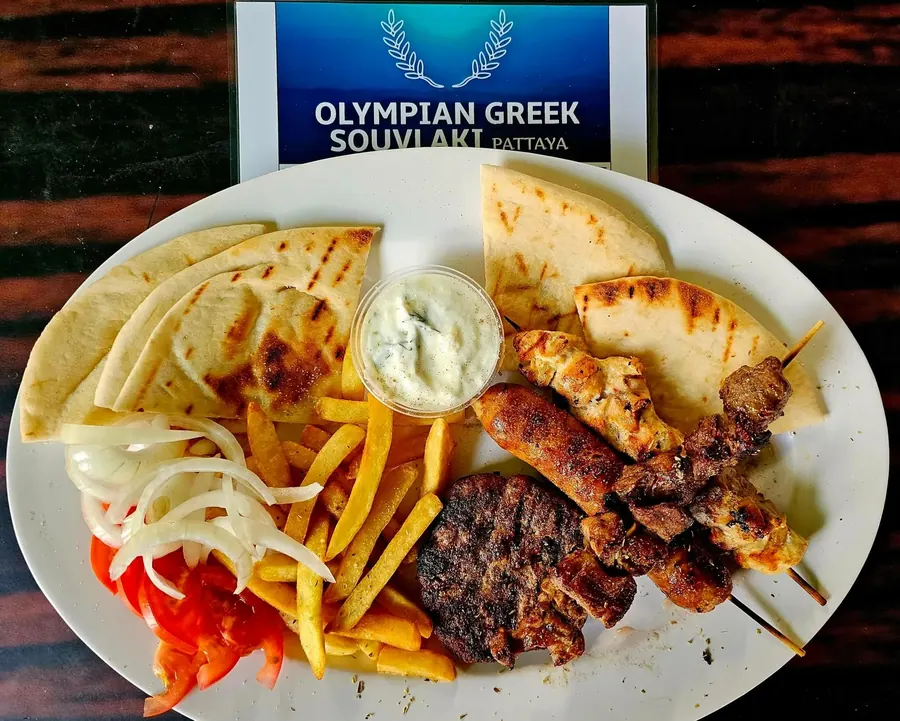 Mixed Greek souvlaki platter with skewers, fries, and salad